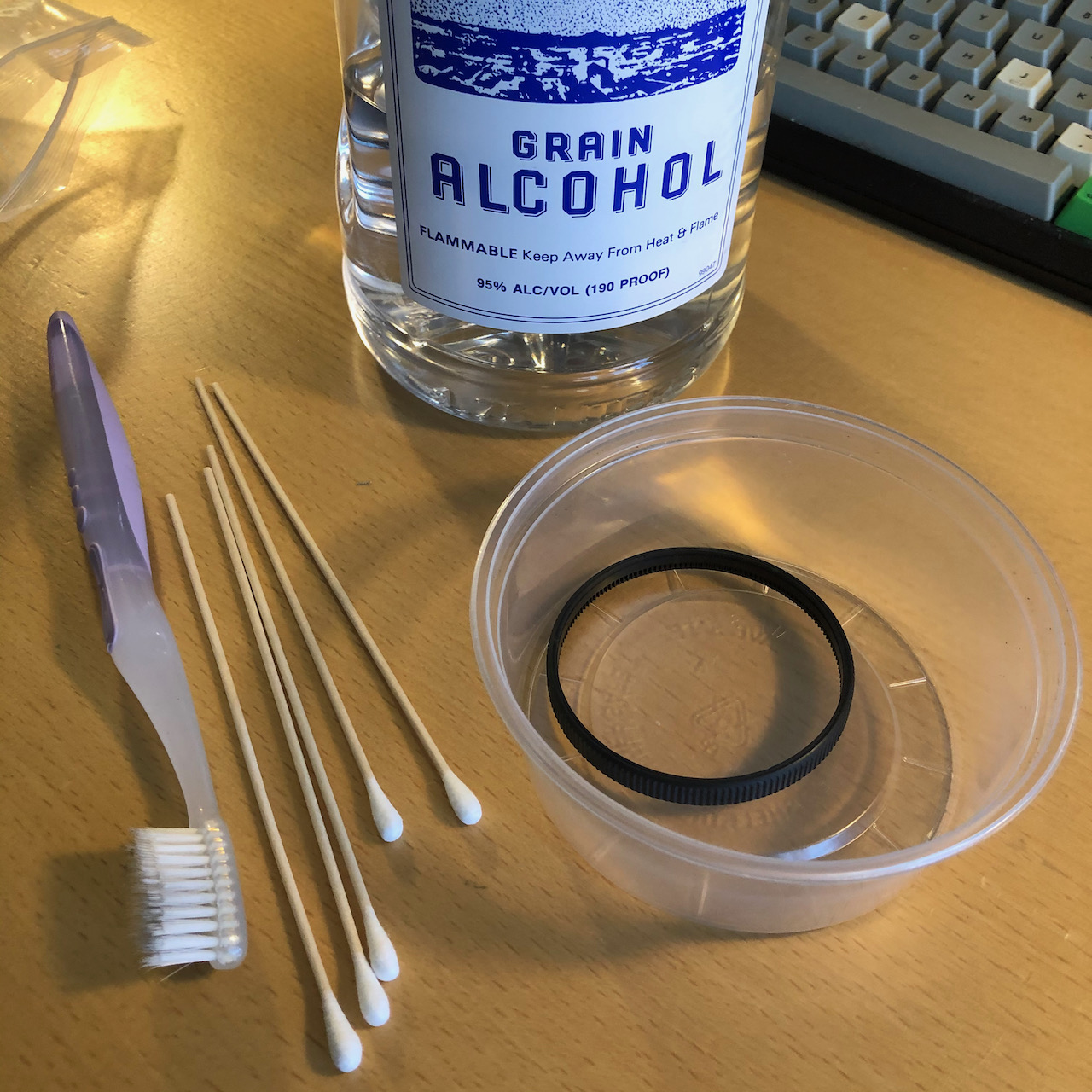 Cleaning the focus ring with alcohol and a toothbrush.